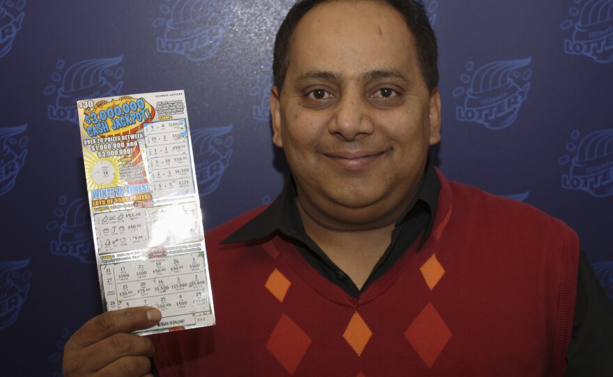 Urooj Khan, with his winning lottery ticket. Not long after this photo was taken, he was dead.