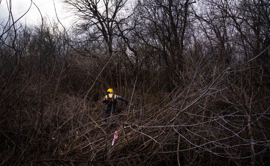 Workers in the area north of Lyman have to be careful to stay in the areas marked by red and white tape, where sappers have already swept for landmines.