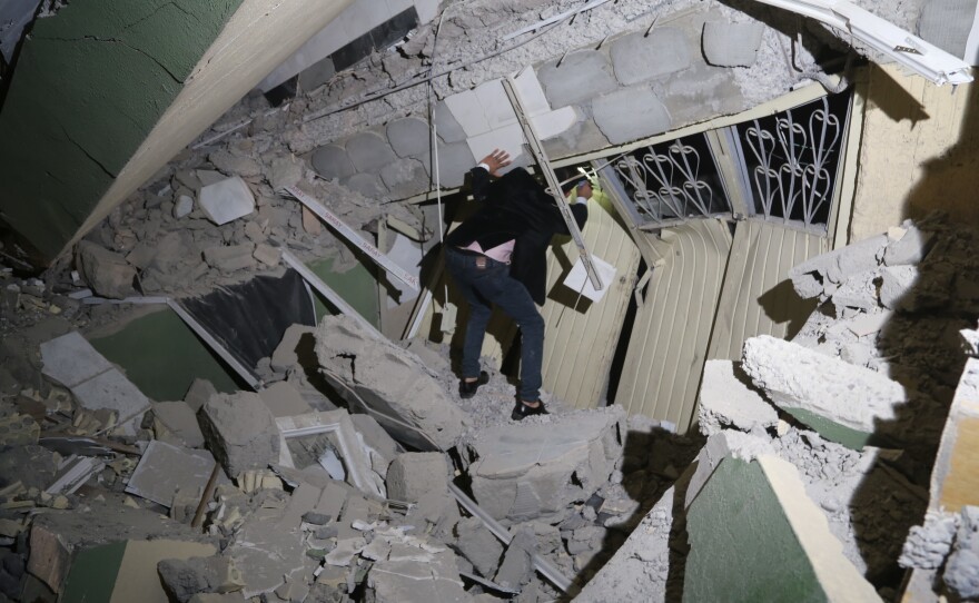 Iraqis search for the trapped citizens over the collapsed buildings after a 7.3 magnitude earthquake hit northern Iraq in Derbendihan district of Sulaymaniyah, Iraq on Sunday.