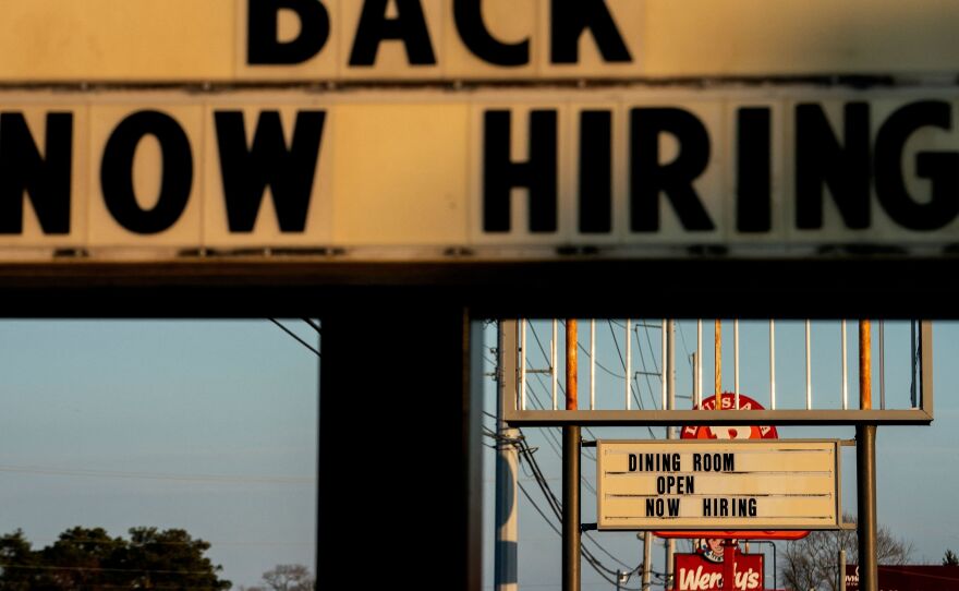 Signs with the message 'Now Hiring' are displayed in front of restaurants in Rehoboth Beach, Delaware, on March 19.