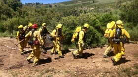 Firefighters practice carrying hoses and cutting brush at Viejas Reservation, April 18, 2019.