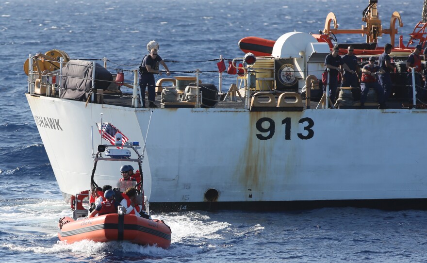 A U.S. Coast Guard crew (foreground) with six Cubans who were picked up in the Florida Straits in May. A larger Coast Guard vessel is in the background. The number of Cubans trying to reach the U.S. has soared in the past year. Many Cubans believe it will be more difficult to enter the U.S. as relations improve, though U.S. officials say there will be no rule changes in the near term.