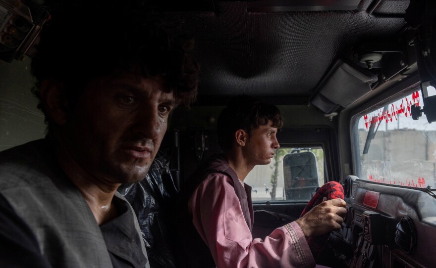 Ahmad Shah, 28, an Afghan policeman, sits in an armored vehicle after being rescued by Afghan special forces, in Kandahar province on July 13, 2021.