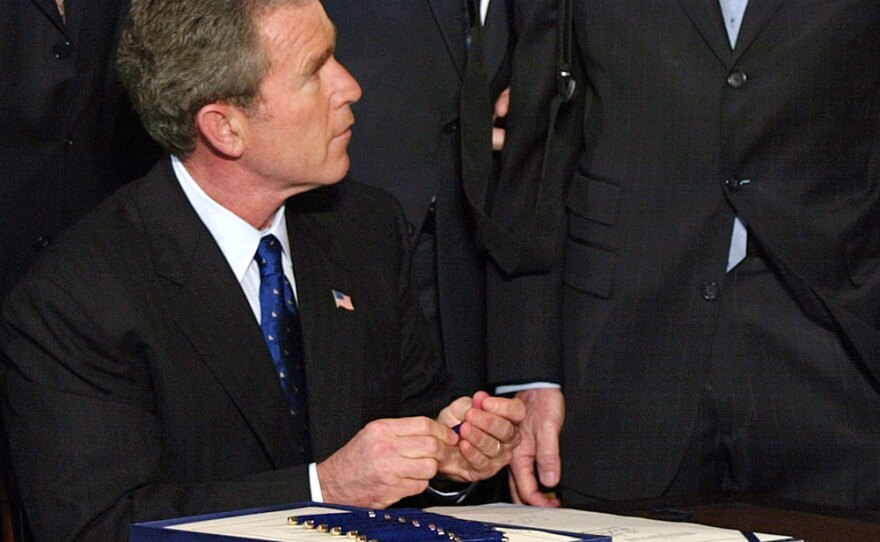 Following the Sept. 11 attacks, President Bush signs the USA Patriot Act into law.