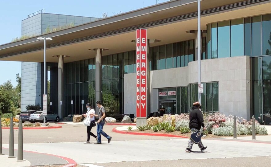 People walking in front of Palomar Medical Center Escondido emergency room, July 1, 2021.