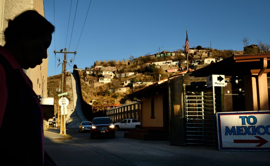 A woman walks toward the international crossing gate in Nogales, Ariz., in March 2013.