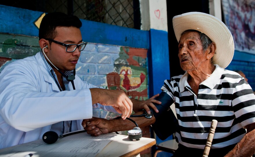 A doctor examines a patient during a June campaign to find chikungunya cases in the town of Ayutuxtepeque, El Salvador. The country reported more than 100,000 cases of chikungunya in 2014.