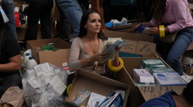 Outside a community center in Bogota, volunteers load boxes with clothes and food onto a truck that will take supplies to victims of Venezuela's earthquake.
