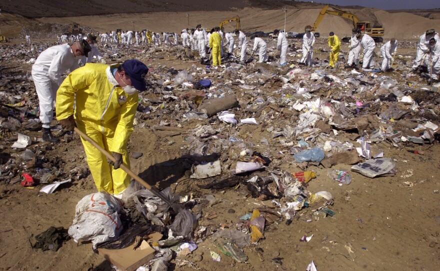 San Diego police, in yellow, and Marines, in white, search the Miramar landfill for clues to the disappearance of 2-year-old Jahi Turner, May 2, 2002.