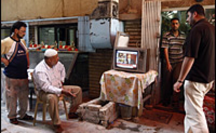 Iraqi men in Baghdad watch a live broadcast on satellite TV of President Obama's speech in Cairo. Obama vowed Thursday to forge a "new beginning" for Islam and America in a landmark speech to global Muslims, evoking a vision of peace after years of smoldering "suspicion and discord."