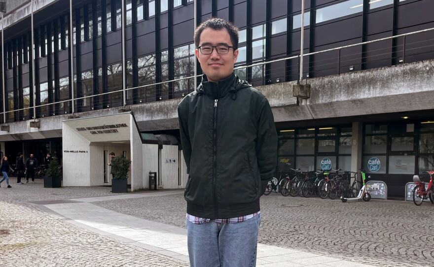 Huang Yicheng poses during an interview with Reuters in Hamburg, Germany, in April. He grew up in China and says he never really thought of leaving. But when Shanghai was locked down, he lost faith.