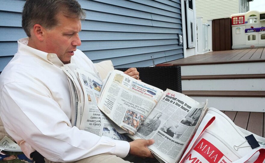 At his home in Haverhill, Mass., Colin LePage leafs through newspapers he shows to middle-schoolers to educate them about the dangers of drugs.