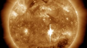 Erupting from active region AR1158 in the sun's southern hemisphere, the flare was captured in extreme ultraviolet image by Nasa's Solar Dynamics Observatory (SDO). The intense burst of electromagnetic radiation above a 60,000 mile-wide dark sunspot momentarily overwhelmed pixels in SDO's detectors, causing the bright vertical blemish.