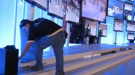 A worker sets up an exhibition booth at the International Consumer Electronics Show.