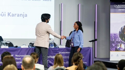 Wambūi Karanja of Kenya accepts the "One to Watch" award from the Alzheimer's Association for the guide she's developed to help family caregivers.