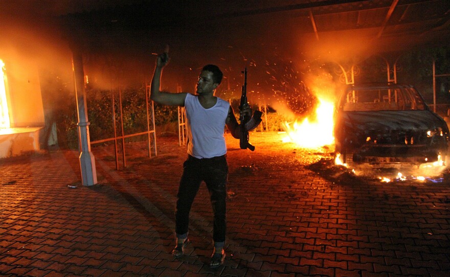 An armed man waves his rifle inside the U.S. diplomatic compound in Benghazi, Libya on Sept. 11, 2012. Four Americans were killed that night, including Ambassador Chris Stevens. U.S. airstrikes helped topple dictator Moammar Gadhafi in 2011, but Libya has descended into chaos since then.