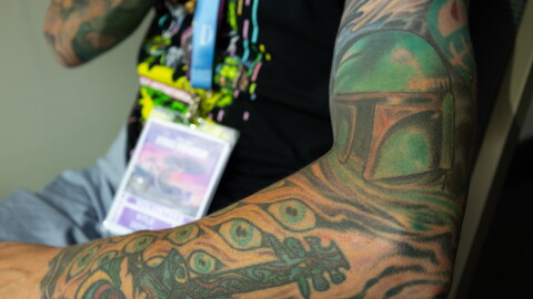 A Star Wars-themed tattoo sleeve featuring Boba Fett is flexed at Comic-Con, July 24, 2026.