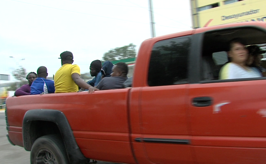 Unknown drivers stop to pick up Haitians and Africans in Tijuana, Sept. 19, 2016.