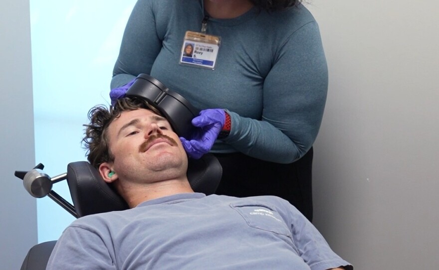 Unidentified patient is connected to a "coil" that creates magnetic fields to treat the brain with Transcranial Magnetic Stimulation (TMS). Undated photo. 