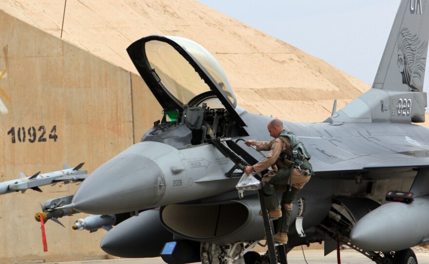 One of the reasons for the shift to unmanned aircraft has been fighter jet budget cuts. Here, a pilot climbs into a U.S. F-16 at Al Asad Air Base in Iraq on Nov. 1. 