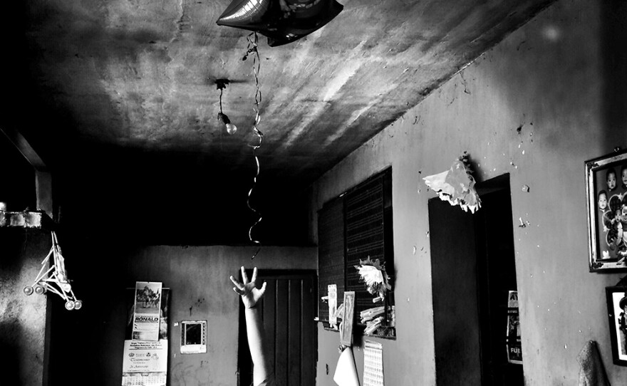 Angel, 8, tries to grab the star balloon his aunt had just brought home from work. Angel's dad is one of the missing 43 students