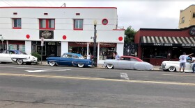 A line of lowriders parked on Logan Avenue in Barrio Logan for the La Vuelta cruise on July 17, 2019. 