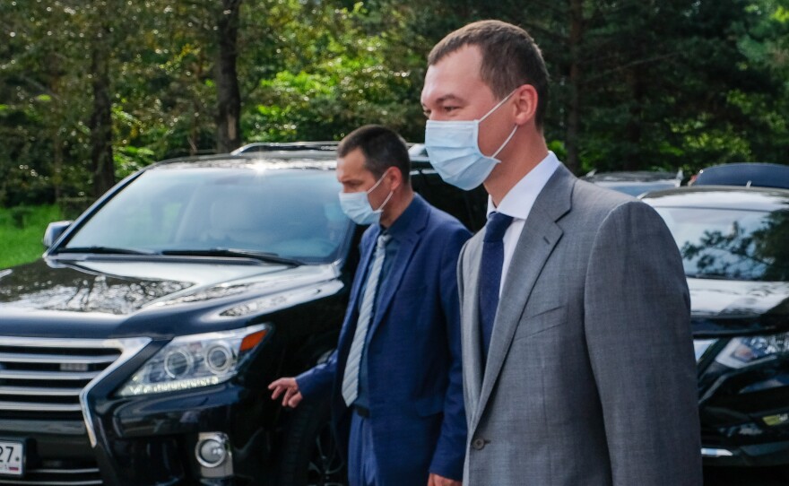 The acting governor of the Khabarovsk region, Mikhail Degtyaryov (right), visits a local hospital on Thursday. Russian President Vladimir Putin appointed him earlier this month. On his first night on the job, protesters chanted, "Degtyaryov, go away!"