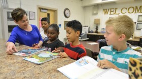 Principal Julie Mahn with students in front office of Thornwell School of the Arts.