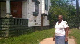 Edith Crum stands in front of a house, owned by out-of-state investors, that she wants torn down.