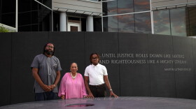 Alabama voters Evan Milligan (left), Sheyann Christburg-Webb and and Tyler Adams meet at the Civil Rights Memorial in Montgomery, Ala.