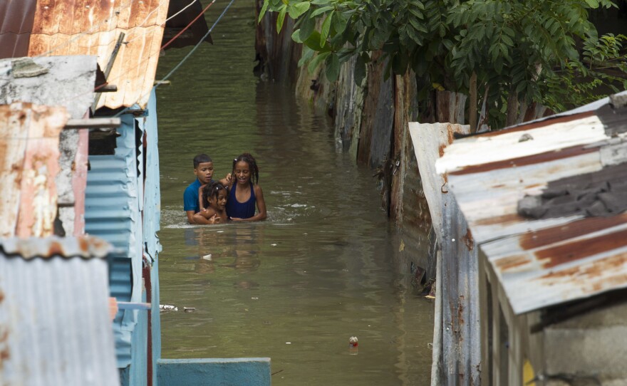 Streets were inundated in a neighborhood in Santo Domingo, Dominican Republic, on Tuesday. Hurricane Matthew dumped rain across the island of Hispaniola, which is split into the Dominican Republic in the east and Haiti to the west.