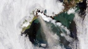A satellite captured the erupting of the Okmok Caldera volcano on Umnak Island in Alaska in July 2008. The volcano spewed both steam and ash.