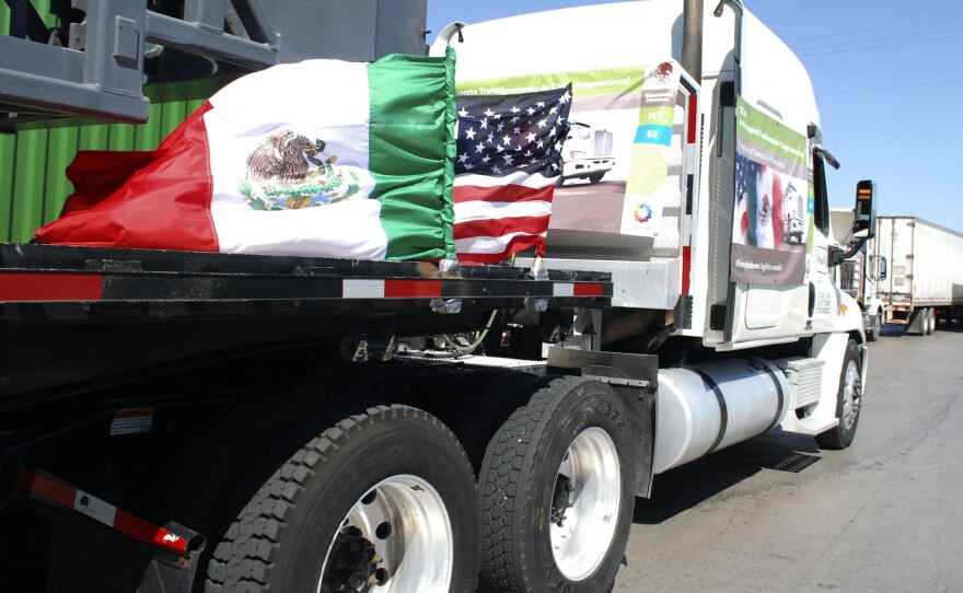 A truck bearing Mexican and U.S. flags approaches the border crossing into the U.S., in Laredo, Texas.