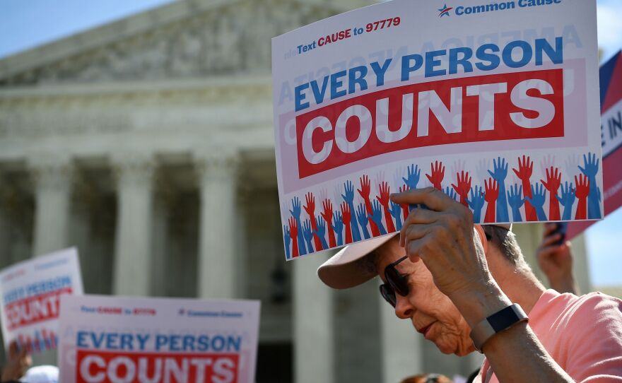 Demonstrators gathered outside the Supreme Court Tuesday to protest the Trump administration's proposal to add a citizenship question to the 2020 Census.
