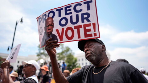 A demonstrator holds a sign saying "PROTECT OUR VOTE!" at a May 16 rally in Montgomery, Ala., responding to the recent U.S. Supreme Court ruling that weakens Voting Rights Act protections against racial discrimination in redistricting.