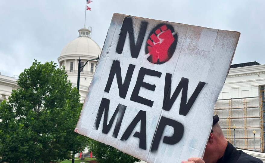 A demonstrator holds up a sign outside the Alabama Statehouse in Montgomery on Thursday.