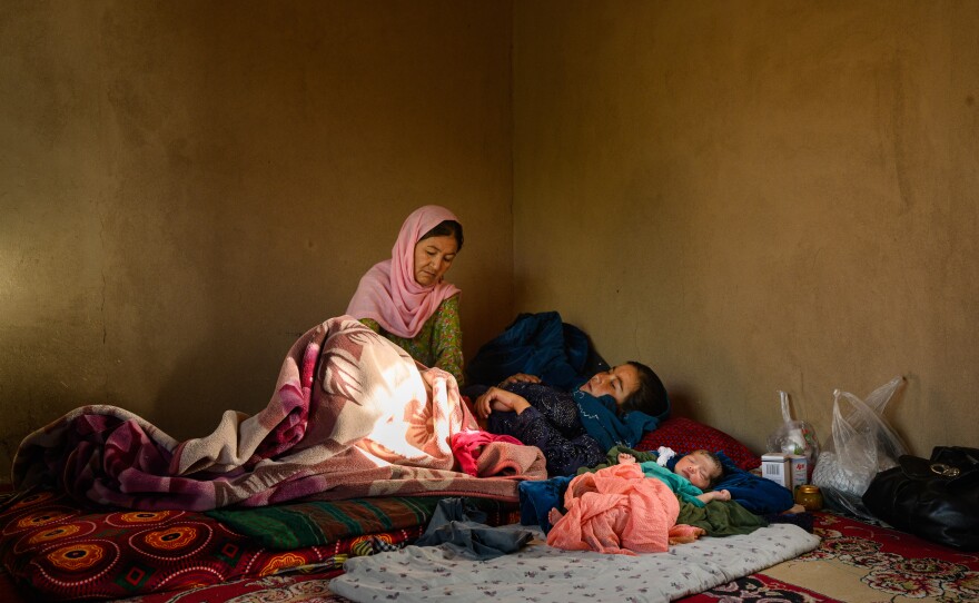 Gulshaman visits Fatemah, whose daughter, Yasmin, was born the previous day. Waras, Shahristan district, Daikundi province, Afghanistan. July 27, 2025