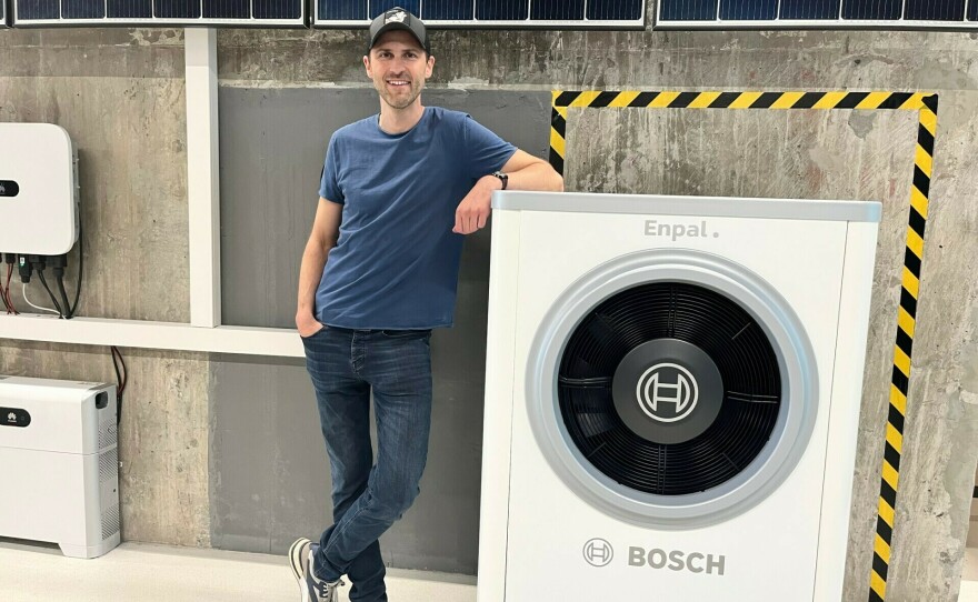Wolfgang Gründinger, with the renewable energy start-up Enpal, stands next to his company's latest offering: a Bosch heat pump that is capable of heating and cooling a single family home. The cost of electricity needed to power a heat pump is a third cheaper than natural gas.