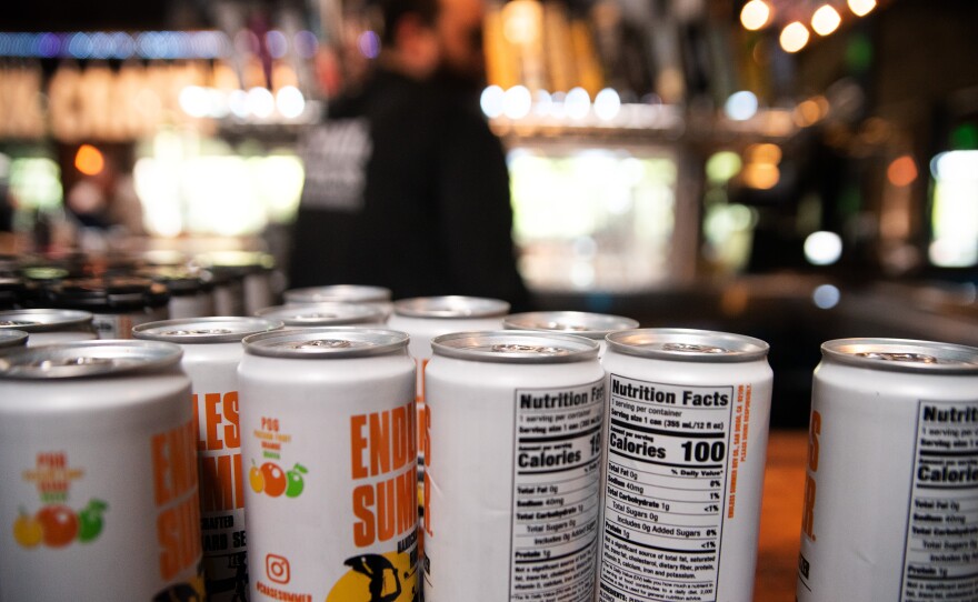Cans line the bar at the Karl Strauss Brewery in Carlsbad, California on Feb. 17, 2025.