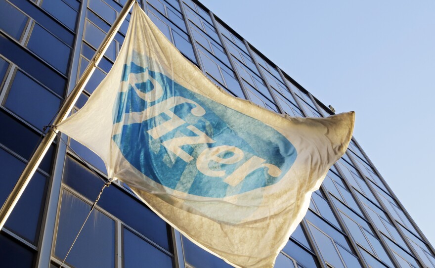 The Pfizer flag flies in front of its world headquarters in New York. Pfizer and Dublin-based Allergan will merge, creating the world's biggest drug-maker by sales.