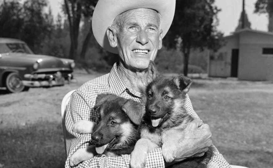Lee Duncan, 67, holds a pair of Rin Tin Tin's descendants, Rin Tin Tin 5 and 6, in 1958.