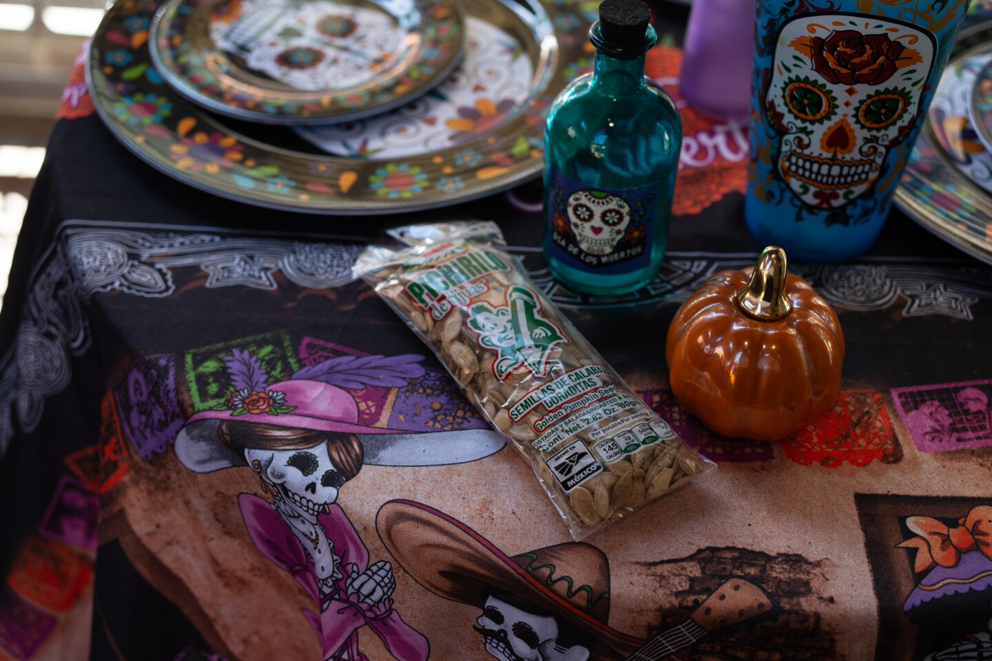 Decorations and a packet of roasted pumpkin seeds adorn an altar table inside the Sherman Heights Community Center in San Diego on Oct. 17, 2023.