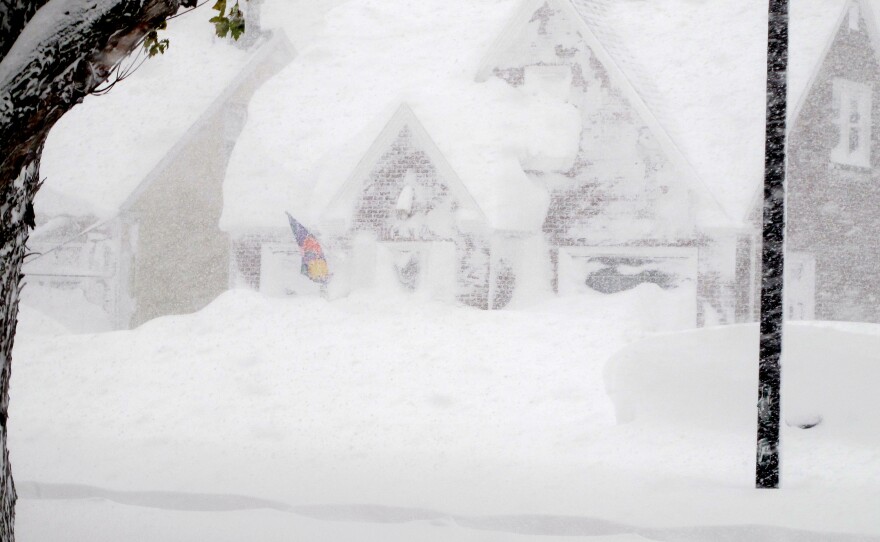 A house is obscured by wind-blown, lake-effect snow on Tuesday.