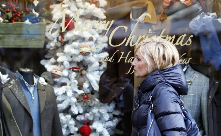 A woman gazes into a shop window in downtown Rome. Due to tough austerity measures, even wealthy Italians are buying less this holiday season.