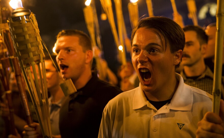 Peter Cvjetanovic (right) chants while holding torches at a march organized by neo-Nazi, white supremacist and white nationalist organizations in Charlottesville, Va., on Friday night.