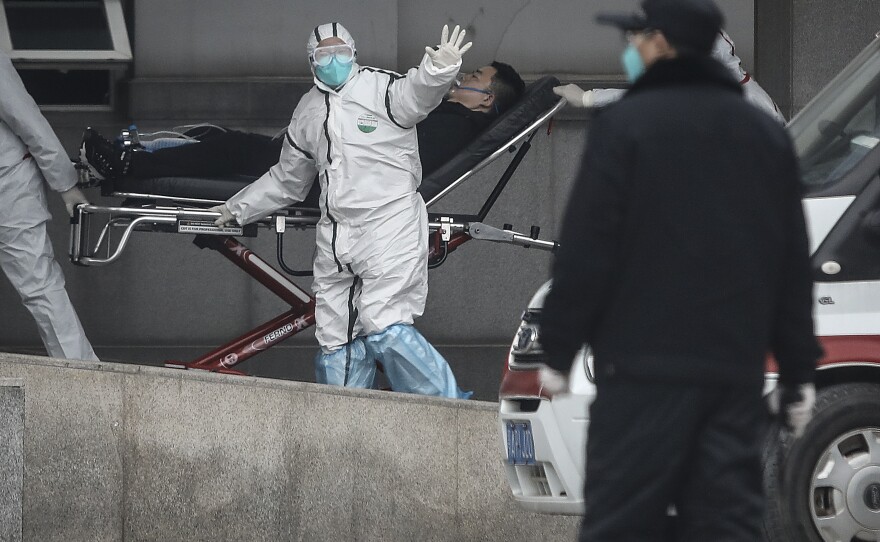 Staff members transfer patients to Jin Yintan hospital in Wuhan on Jan. 17, 2020.