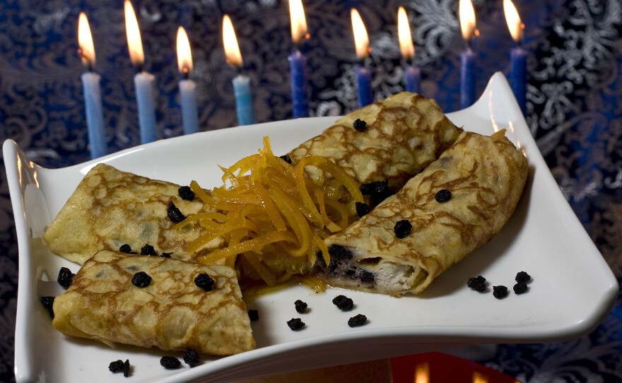Lemon and dried blueberry blintzes, filled with creamy ricotta cheese, provide a tasty way to serve dairy and honor Judith for Hanukkah.