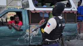 A police officer stands guard in Port-au-Prince, Haiti, Tuesday, March 3, 2026.