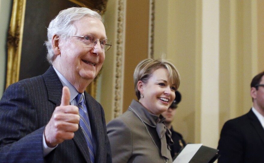 Senate Majority Leader Mitch McConnell, R-Ky., gives a thumbs up as he leaves the Senate chamber during the impeachment trial of President Trump on Friday.