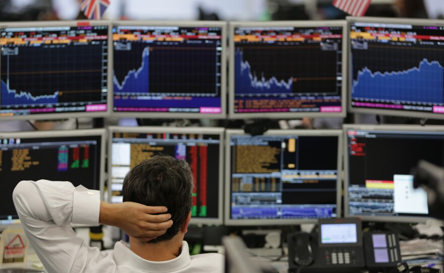 Traders at work at ETX Capital work in central London on Monday. Financial markets in the U.K. and around the world have been in turmoil since the Brexit vote last week.